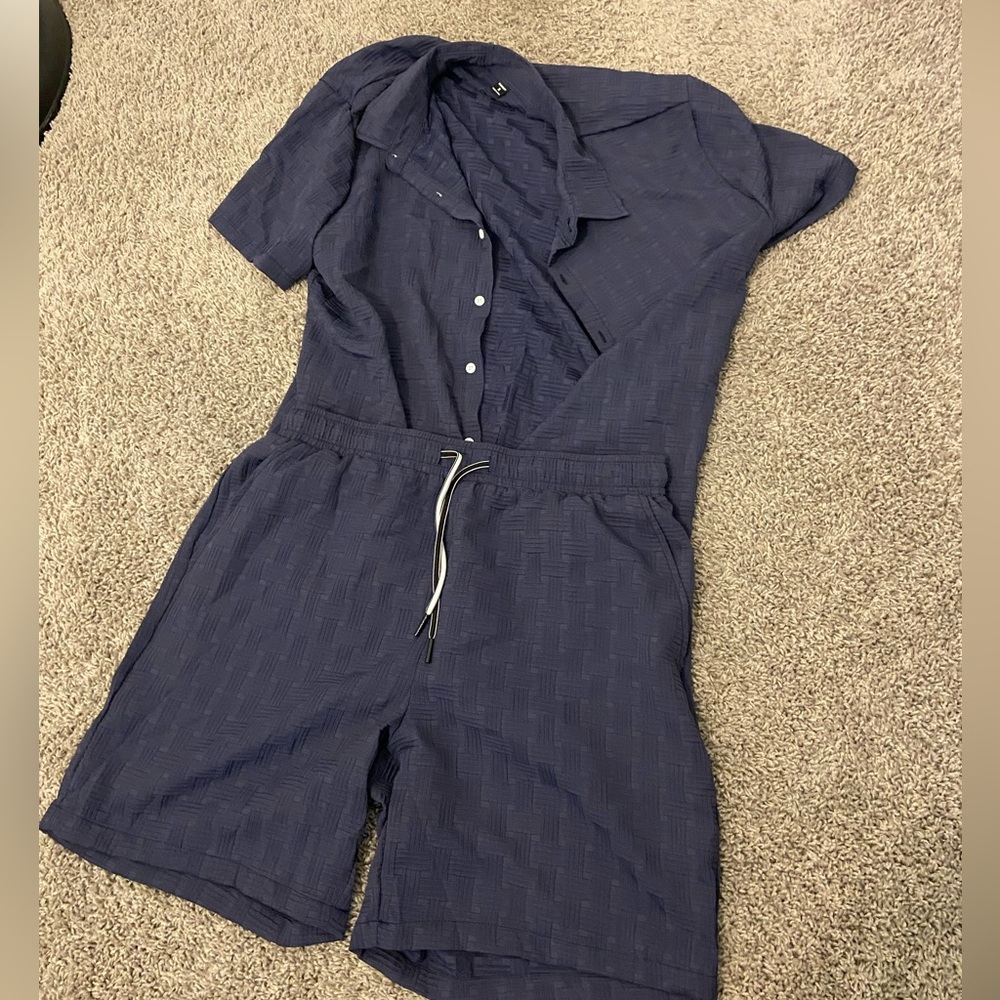 Light blue buttoned up shirt paired with its same colored string shorts
